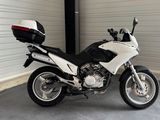 a motorcycle parked in a garage with a helmet on
