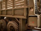 a military truck that is parked in a garage
