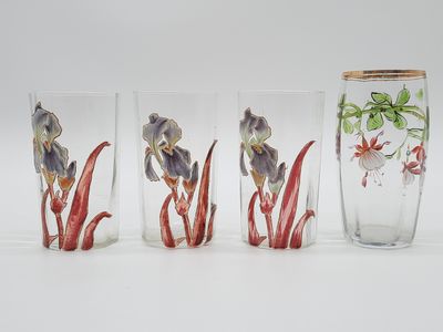 three glass vases with flowers painted on them sitting next to each other