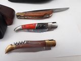 four different types of knives on a white surface