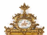 a gold frame with a picture of a horse and rider on it