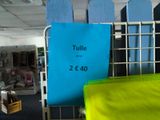 a sign that says tulle on the side of a rack