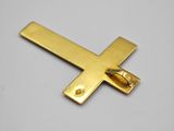 a close up of a gold cross on a white surface