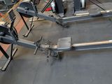 two machines that are sitting on the floor in the gym