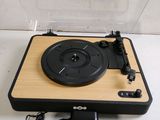 a record player sitting on top of a wooden table