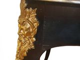 a black and gold table with a gold lion head on it