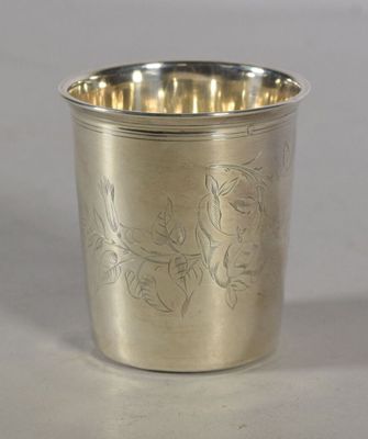 a silver cup with a bird design on it