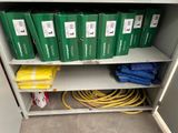 a shelf with a bunch of boxes and hoses on it