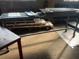 many pieces of metal sitting on pallets in a room