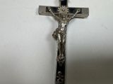 silver crucifix with jesus on the cross on a white background