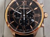 the watch is black and gold with a black face