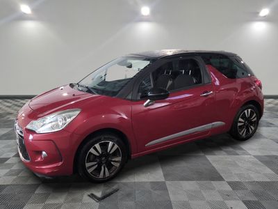 the red citrole is parked in a large room with a checkered floor