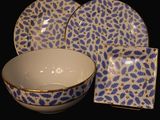 a blue and white bowl and plate set on a black background