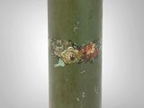 a green vase with a red and yellow decoration on it