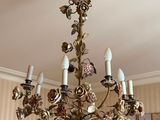 a chandelier that has a bunch of flowers on it