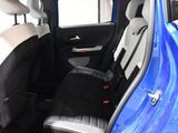 a blue car with a black seat cover in the back of it
