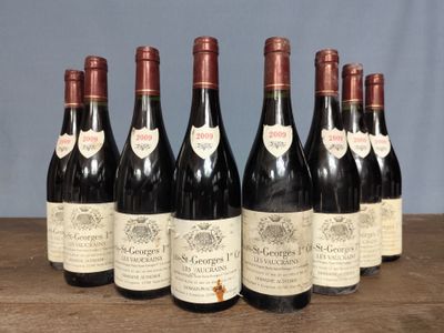 six bottles of wine are lined up on a wooden table