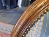 a close up of a chair with a wooden frame