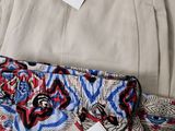 three pairs of pants with a price tag on them sitting on a table