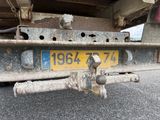 the rear end of a truck with a number plate on it ' s bumper