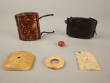 three pieces of wood and a leather case on a table