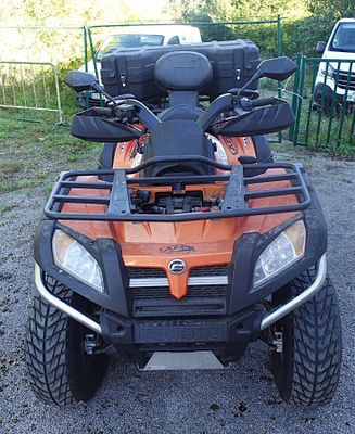 an image of a four wheeler utility vehicle parked in a lot