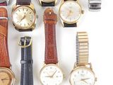 a lot of different types of watches on a white surface
