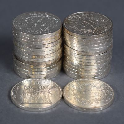 several stacks of coins sitting on top of each other on a table