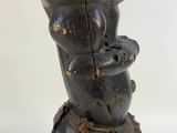 an image of a wooden sculpture of a woman holding a baby