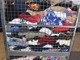 a metal cart with a bunch of clothes on it