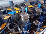 many different types of valves on a pallet in a warehouse