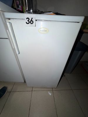 a white refrigerator with a number on it in a kitchen