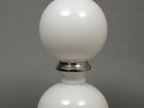 a white lamp that is sitting on a table