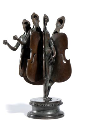 statue of a man and a woman playing a musical instrument on a pedestal