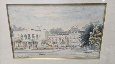 aquarelle encadrée représentant une scène de rue avec des bâtiments et des arbres