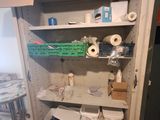 a room that has a bunch of items on the shelves