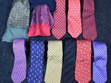 several different colored ties laid out in a row on a blue carpet