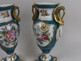 pair of blue and white vases with gold handles and flowers