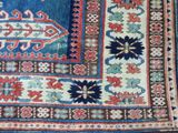 an image of a blue and red rug with a design on it