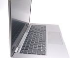 a silver laptop computer sitting on top of a white table