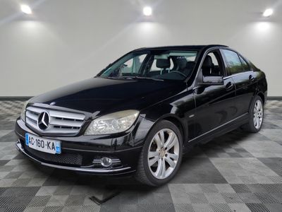 the mercedes c - class is parked on a checkered floor