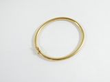 an image of a gold ring on a white surface