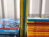 several books are stacked on top of each other on a table