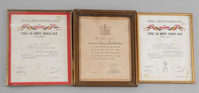 three framed pictures of military medals on display on a wall