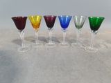 six different colored wine glasses lined up in a row