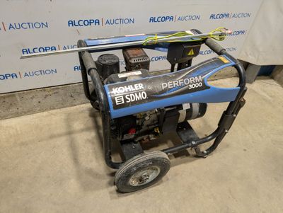 the generator is sitting on the floor in front of the wall