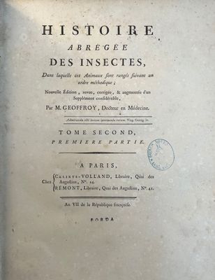 an old book with writing on it sitting on a table