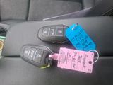 three car keys and a cup of coffee on a car seat