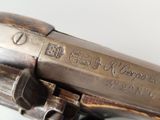 a close up of a gun on a white surface