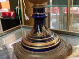 a blue vase sitting on top of a glass table